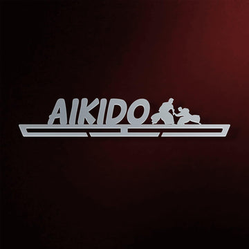 Aikido Medal Hanger in laser-cut steel on a dark background