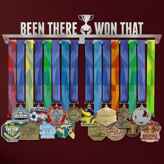 Been There Won That Medal Hanger holding a full row of medals on a wall