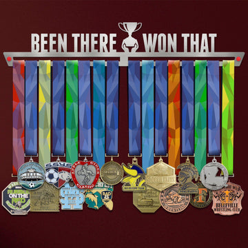Been There Won That Medal Hanger holding a full row of medals on a wall