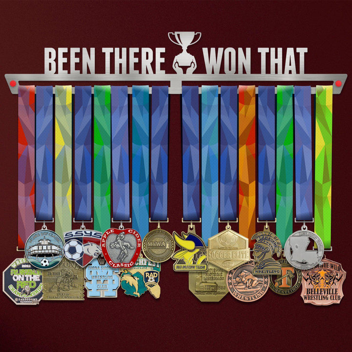Been There Won That Medal Hanger holding a full row of medals on a wall