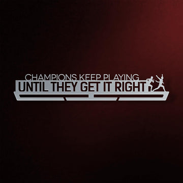 Champions Keep Playing Medal Hanger in laser-cut steel on a dark background