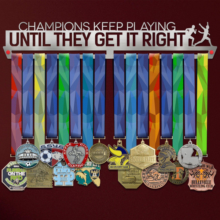 Champions Keep Playing Medal Hanger holding a full row of medals on a wall