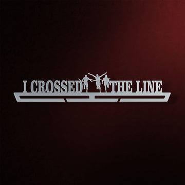 I Crossed The Line Medal Hanger in laser-cut steel on a dark background