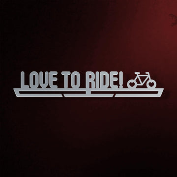 Love To Ride Medal Hanger in laser-cut steel on a dark background