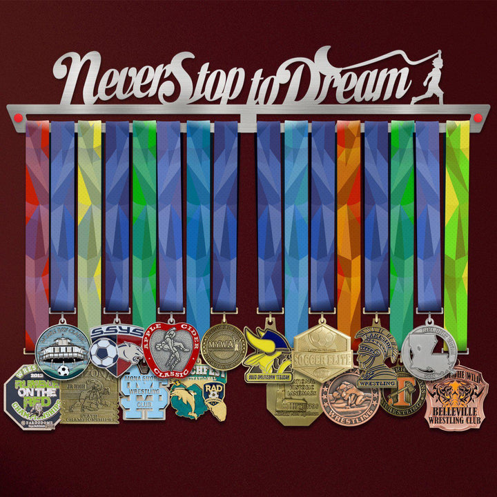 Never Stop To Dream Medal Hanger holding a full row of medals on a wall