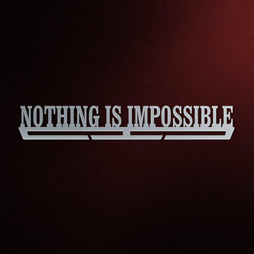 Nothing Is Impossible Medal Hanger in laser-cut steel on a dark background