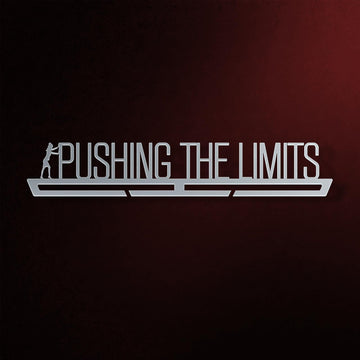 Pushing The Limits Medal Hanger in laser-cut steel on a dark background