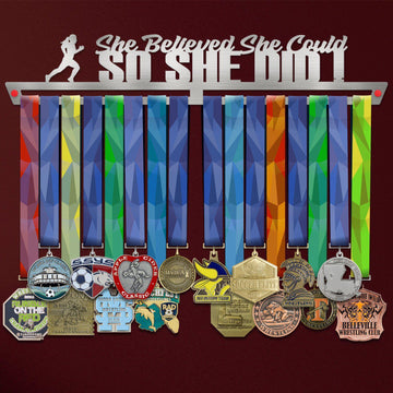 She Believed She Could So She Did Medal Hanger holding a full row of medals on a wall