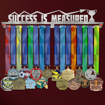 Success Is Measured Medal Hanger holding a full row of medals on a wall