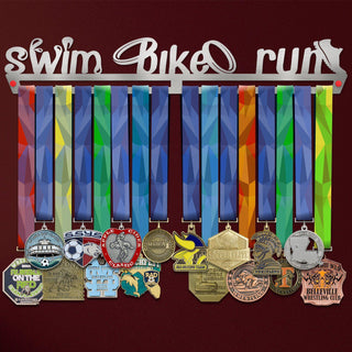 Swim Bike Run Medal Hanger V2 holding a full row of medals on a wall