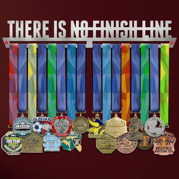There Is No Finish Line Medal Hanger holding a full row of medals on a wall