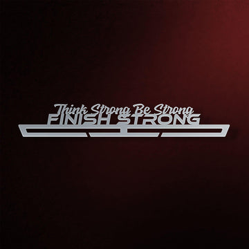 Finish Strong Medal Hanger in laser-cut steel on a dark background