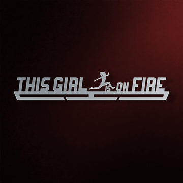 This Girl Is On Fire Medal Hanger in laser-cut steel on a dark background