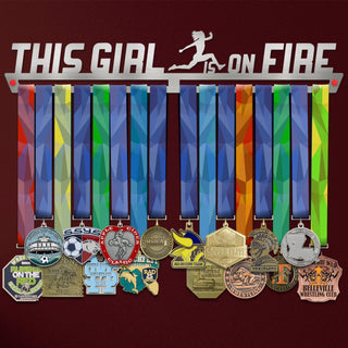 This Girl Is On Fire Medal Hanger holding a full row of medals on a wall