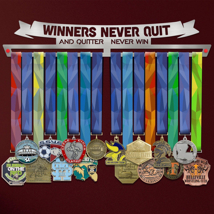Winners Never Quit Medal Hanger holding a full row of medals on a wall